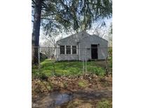 Cozy single-story home with a fenced yard and mature shade tree at 2018 N Dearborn St, Indianapolis, IN 46218