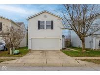 Two-story house with white siding, attached garage, and a neatly landscaped yard at 2716 Redland Ln, Indianapolis, IN 46217