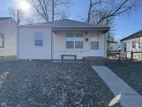 Cute bungalow with a covered porch, steps, and small front yard at 3305 E 30Th St, Indianapolis, IN 46218
