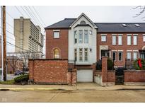Brick townhouse with a two-car garage and a well-manicured front yard at 502 Lockerbie S Cir, Indianapolis, IN 46202