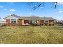 Brick ranch house with a spacious lawn and mature trees at 5249 Hickory Rd, Indianapolis, IN 46239