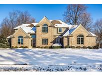 Brick two-story home with snow-covered lawn at 7488 River Highlands Dr, Fishers, IN 46038