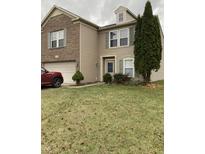 Two-story brick home with attached garage and landscaped lawn at 759 Harvest Meadow Way, Whiteland, IN 46184