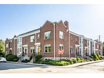 Charming brick townhomes featuring well-manicured landscaping and classic architectural details, enhancing curb appeal at 1003 Alabama St, Indianapolis, IN 46202