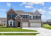 Beautiful two-story brick home with a three-car garage and manicured lawn at 1069 Ridgevine Rd, Greenwood, IN 46143