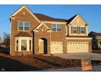 Beautiful two-story brick home with a two-car garage and manicured front yard at 1069 Ridgevine Rd, Greenwood, IN 46143