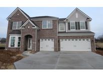 Two-story brick home with three-car garage and large driveway at 1069 Ridgevine Rd, Greenwood, IN 46143