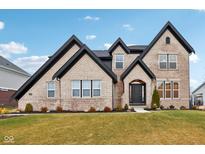 Two-story brick home with a black roof and landscaping at 12458 Palmetto Bay St, Fishers, IN 46037