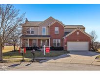 Charming two-story brick home featuring an attached two-car garage and well-manicured front lawn at 18822 Gusset Ct, Noblesville, IN 46062