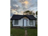 Newly renovated home exterior boasts white siding and a black roof at 2722 Collier St, Indianapolis, IN 46241
