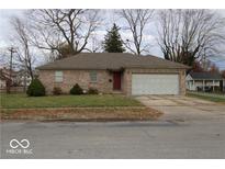 Brick ranch home with attached garage and mature trees at 295 N Mill St, Plainfield, IN 46168