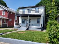 Two-story house with white siding, black accents, and a front porch at 3156 Graceland Ave, Indianapolis, IN 46208