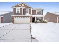 Two-story house with a white garage door and snow-covered driveway at 6232 Emerald Springs Dr, Indianapolis, IN 46221