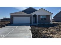 Charming brick home with an attached two-car garage and professionally designed landscaping at 885 Saddlebrook Farms Blvd, Whiteland, IN 46184