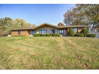 Brick ranch home with a landscaped yard and mature trees at 89 Hillview Dr, Martinsville, IN 46151