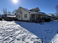 Cute bungalow with front porch, covered by snow at 1709 W 11Th St, Muncie, IN 47302