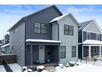 Two-story modern home with gray siding, snow covered lawn, and black fence at 1727 N College Ave, Indianapolis, IN 46202