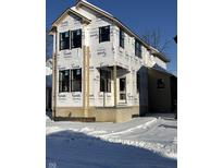 New construction home exterior; two-story design, covered porch, snow on ground at 2021 Cornell Ave, Indianapolis, IN 46202