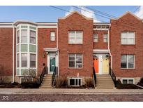 Brick townhouses with front steps and colorful doors at 310 E 10Th St, Indianapolis, IN 46202