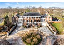 Impressive brick manor house with circular driveway and manicured landscaping at 4601 N Legacy Dr, Muncie, IN 47304