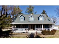 Charming home featuring a covered porch, three dormer windows, and light blue siding at 5682 N Michigan Rd, Fairland, IN 46126