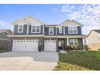 Two-story home with navy siding, brick accents, and a three-car garage at 6324 Bales Dr, Plainfield, IN 46168