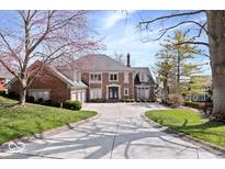 Beautiful brick home featuring a circular driveway and well-manicured front lawn at 10901 Brigantine Dr, Indianapolis, IN 46256