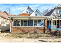 Charming blue house with brick details and a welcoming front porch at 1745 S Talbott St, Indianapolis, IN 46225