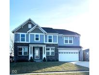 Two-story home with gray and blue siding, brick accents, and a three-car garage at 2449 Lingerman Way, Avon, IN 46123