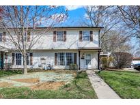 Charming two-story home with a walkway leading to the front door and green lawns on a sunny day at 4814 Oakwood Trl, Indianapolis, IN 46268