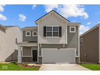 Charming two-story home with gray siding, white accents, and an attached two-car garage at 5123 Rolling Meadow Blvd, Indianapolis, IN 46237