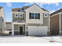 Charming two-story home featuring a two-car garage and a welcoming front porch at 5123 Rolling Meadow Blvd, Indianapolis, IN 46237