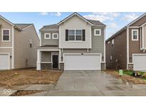Charming two-story home features a two-car garage, covered entry, and stone accents at 5123 Rolling Meadow Blvd, Indianapolis, IN 46237