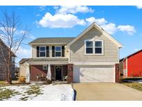 Two-story house with neutral siding, brick accents, and a two-car garage at 5559 W Woods Edge Dr, McCordsville, IN 46055