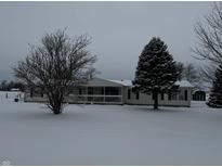 Ranch home with covered porch, winter scene at 7600 Meadowview Ln, Martinsville, IN 46151