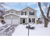 Two-story house with attached garage and snowy front yard at 7802 Hardwick Pl, Fishers, IN 46038