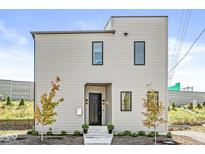Modern two-story home with light beige siding and a black front door at 1219 E 15Th St, Indianapolis, IN 46202