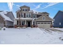 Two-story house with a snow-covered front yard and attached two-car garage at 15834 Arthur Jacob Ln, Noblesville, IN 46060