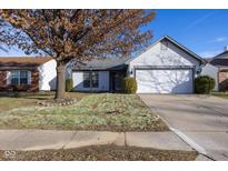 Ranch home with attached garage and landscaped yard at 2233 Historic Oaks Blvd, Indianapolis, IN 46214