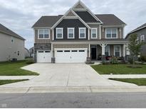 Two-story house with a large front yard, double garage, and stone accents at 5126 Sagebrook Blvd, Indianapolis, IN 46239
