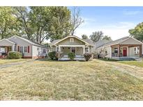 Charming craftsman home with a spacious lawn and welcoming porch at 5137 Ralston Ave, Indianapolis, IN 46205