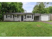 Charming single-story home with gray siding, black shutters, well-maintained lawn, and attached carport at 5807 Westhaven Dr, Indianapolis, IN 46254