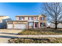 Charming two-story home with a two-car garage and well-maintained front lawn, perfect for suburban living at 5838 W Bayfield Dr, McCordsville, IN 46055