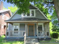 Charming home featuring a covered front porch, classic architectural details, and a well-maintained exterior at 1138 W 33Rd St, Indianapolis, IN 46208