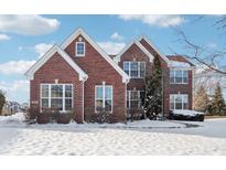 Brick two-story home with snow-covered lawn at 13172 Antonia Blvd, Carmel, IN 46074