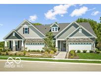 Two-story craftsman style home with stone accents and a three-car garage at 17242 Cole Evans Dr, Noblesville, IN 46060