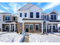 Two-story townhome with stone and white siding, snow-covered yard at 19456 Northwest Dr, Westfield, IN 46074