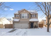 Two-story house with gray siding, a two-car garage, and a snow-covered front yard at 2359 Shoemaker Ct, Indianapolis, IN 46229