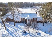 Brick home with snow covered roof and expansive lawn at 2940 Washington St, Columbus, IN 47201