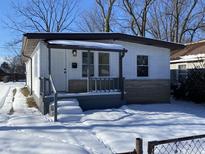 Newly renovated ranch home with snow covered front yard at 3038 N Gladstone Ave, Indianapolis, IN 46218